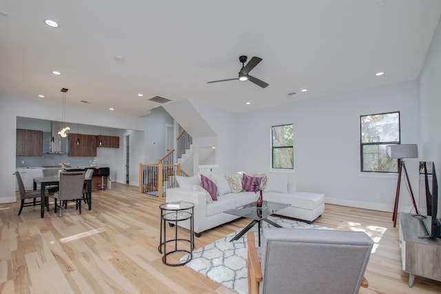 living area featuring stairway, recessed lighting, visible vents, and light wood finished floors