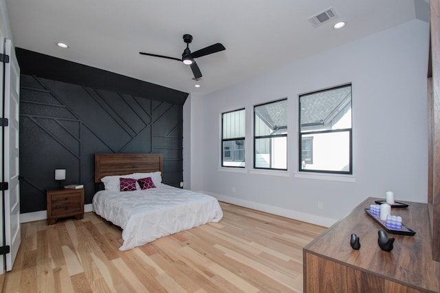 bedroom with baseboards, recessed lighting, visible vents, and light wood-type flooring