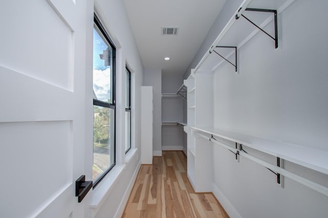 walk in closet with visible vents and light wood-type flooring