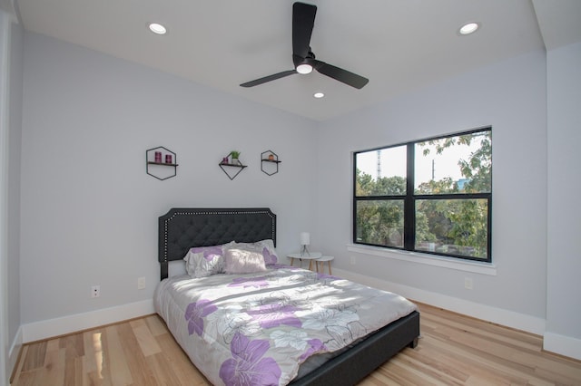 bedroom with recessed lighting, baseboards, and light wood-style floors