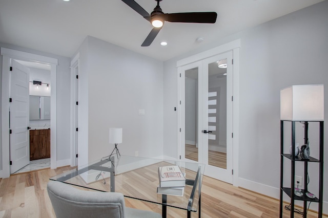 office space featuring french doors, baseboards, light wood finished floors, and ceiling fan