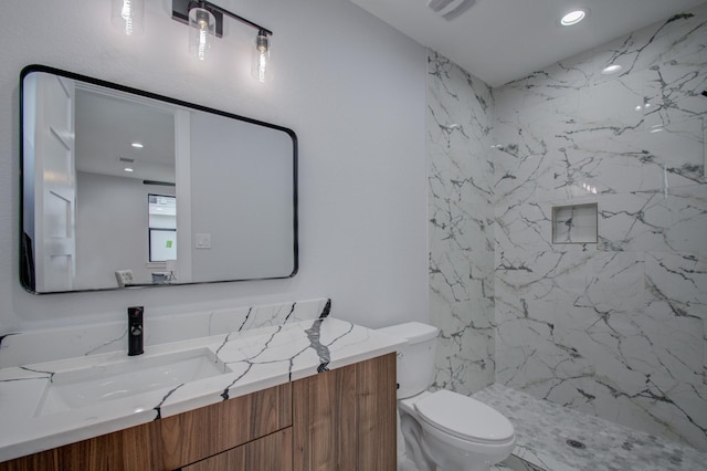 bathroom featuring a marble finish shower, visible vents, toilet, recessed lighting, and vanity