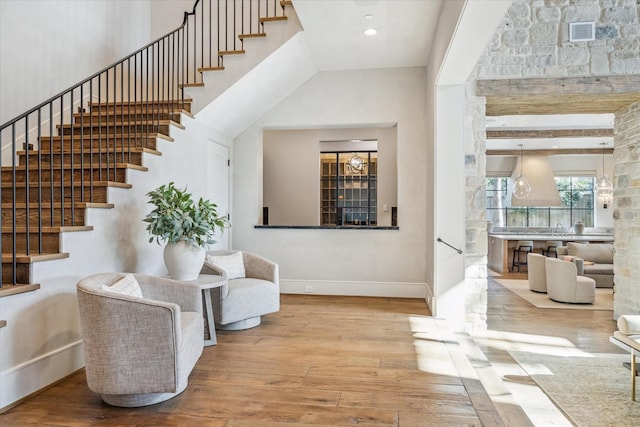 entrance foyer featuring visible vents, baseboards, stairs, recessed lighting, and wood-type flooring