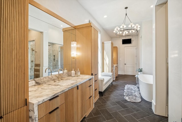 full bathroom with vanity, an inviting chandelier, a soaking tub, and a shower stall