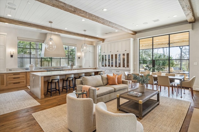 living area with recessed lighting, beamed ceiling, wood ceiling, and hardwood / wood-style floors