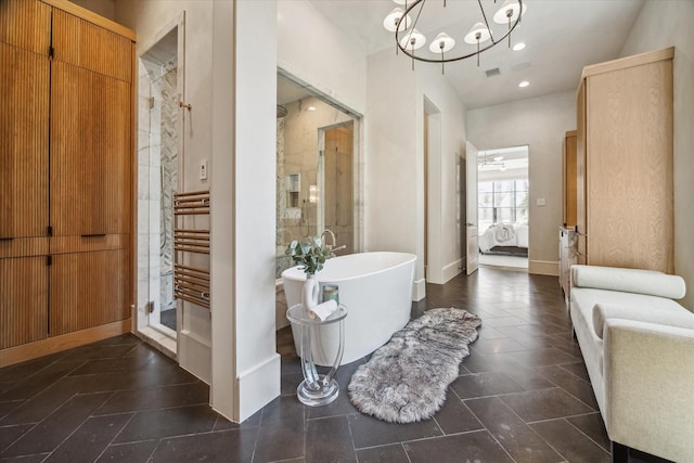 full bathroom featuring recessed lighting, connected bathroom, a shower stall, baseboards, and a soaking tub