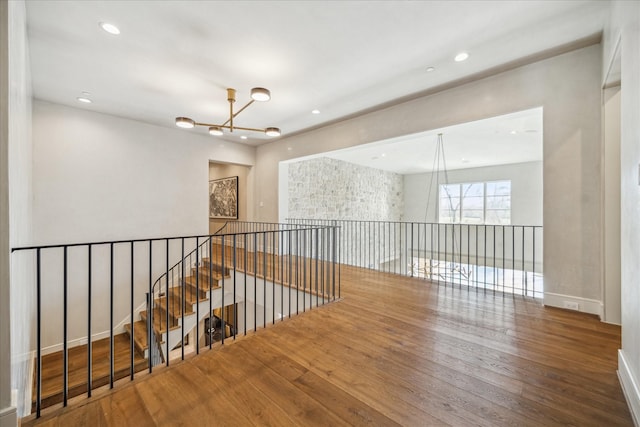 hall with a notable chandelier, recessed lighting, and hardwood / wood-style floors