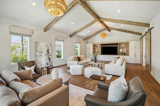 living room with a barn door, vaulted ceiling with beams, wood finished floors, and baseboards