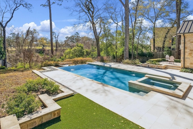 view of pool featuring a pool with connected hot tub and fence