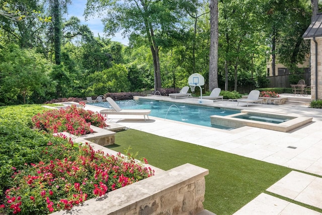 outdoor pool with a patio, an in ground hot tub, and fence