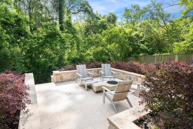 view of patio / terrace featuring a fire pit and fence