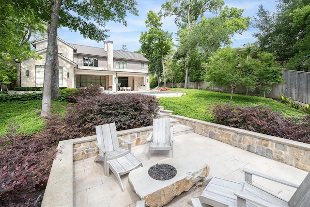 view of patio featuring a fenced backyard and an outdoor fire pit