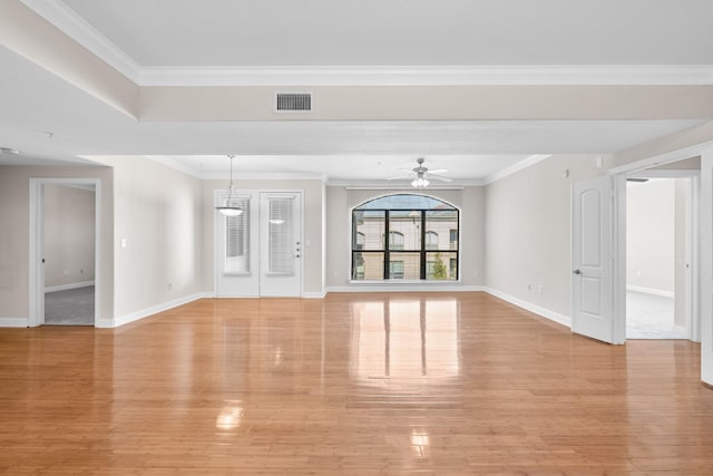 unfurnished living room with baseboards, visible vents, light wood-style flooring, ceiling fan, and crown molding