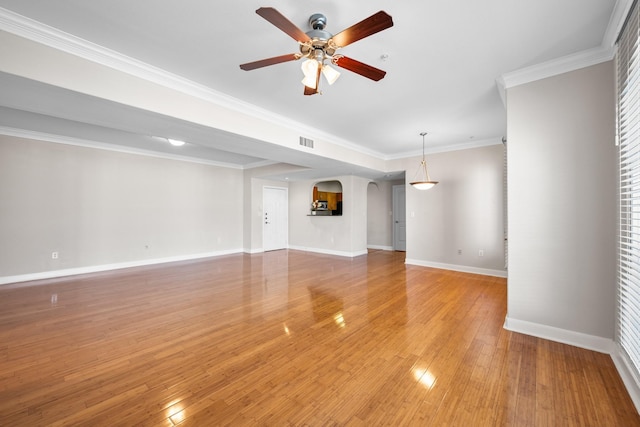 unfurnished living room with baseboards, visible vents, light wood-style flooring, ceiling fan, and ornamental molding