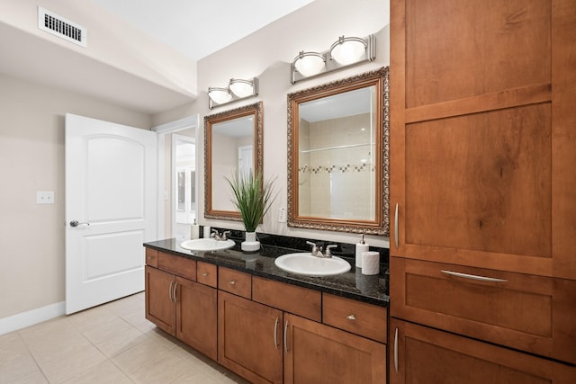 full bathroom featuring double vanity, a shower, visible vents, and a sink