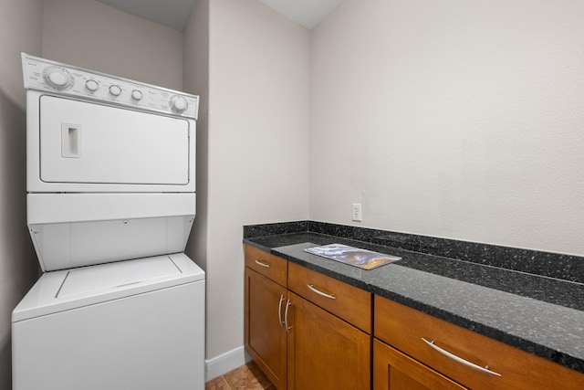 laundry area with laundry area and stacked washer / drying machine