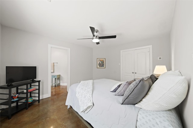 bedroom featuring a closet, a ceiling fan, concrete flooring, and baseboards