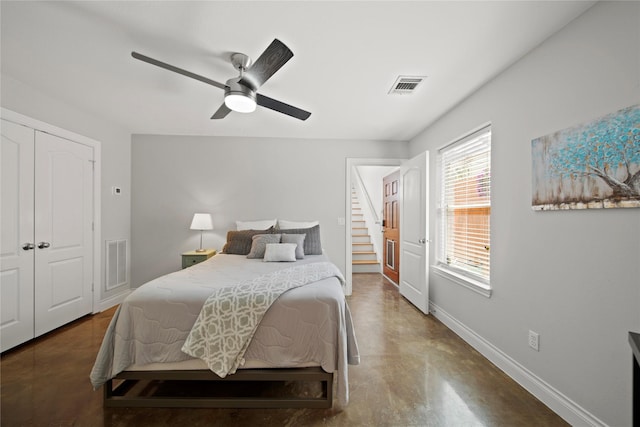 bedroom featuring visible vents, ceiling fan, concrete flooring, and baseboards