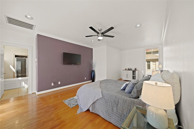 bedroom with recessed lighting, wood finished floors, visible vents, and baseboards