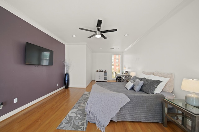 bedroom featuring a ceiling fan, wood finished floors, baseboards, recessed lighting, and crown molding