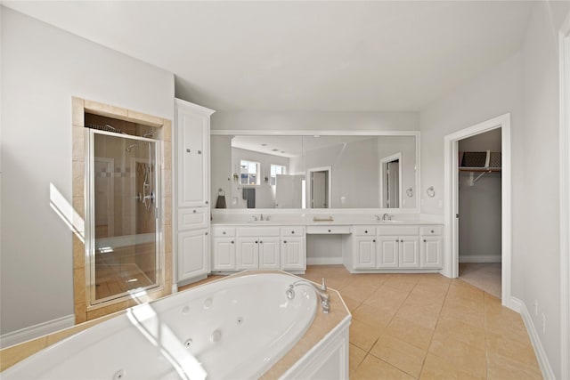 full bath with a tub with jets, double vanity, a stall shower, a sink, and tile patterned flooring