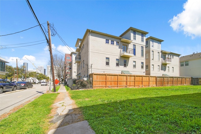 exterior space with a lawn and fence