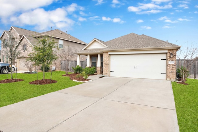 view of front of home with driveway, brick siding, a front yard, and fence