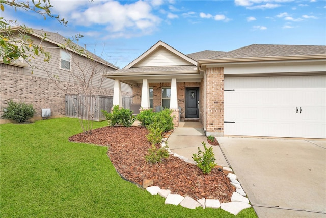 view of front of property with brick siding, a front lawn, a porch, roof with shingles, and a garage