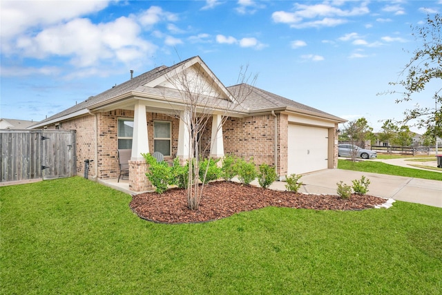 view of front facade with brick siding, driveway, a front lawn, and fence