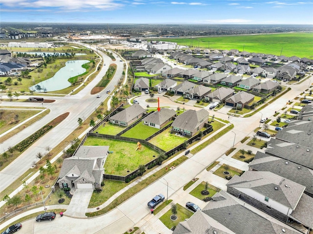 birds eye view of property featuring a residential view and a water view