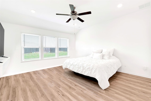 bedroom featuring visible vents, baseboards, and wood finished floors