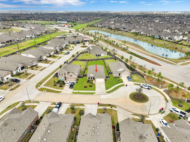 birds eye view of property with a residential view and a water view