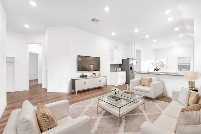 living room featuring visible vents, recessed lighting, and light wood-style floors