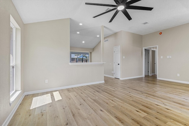 unfurnished living room with visible vents, lofted ceiling, baseboards, and wood finished floors