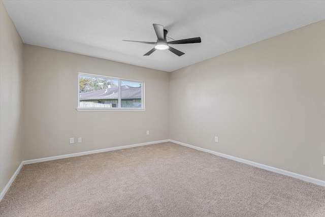 unfurnished room with a ceiling fan, baseboards, and carpet floors