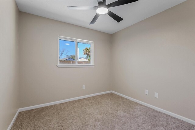 empty room featuring baseboards and carpet flooring