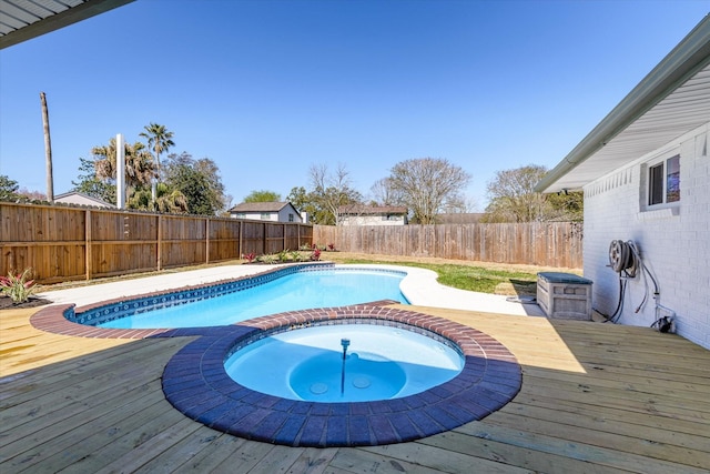 view of swimming pool with a deck, an in ground hot tub, and a fenced backyard