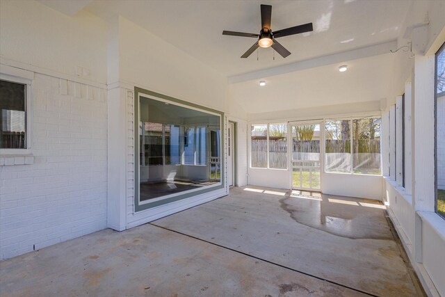 unfurnished sunroom featuring lofted ceiling and ceiling fan