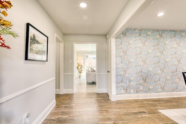 corridor featuring recessed lighting, baseboards, and wood tiled floor