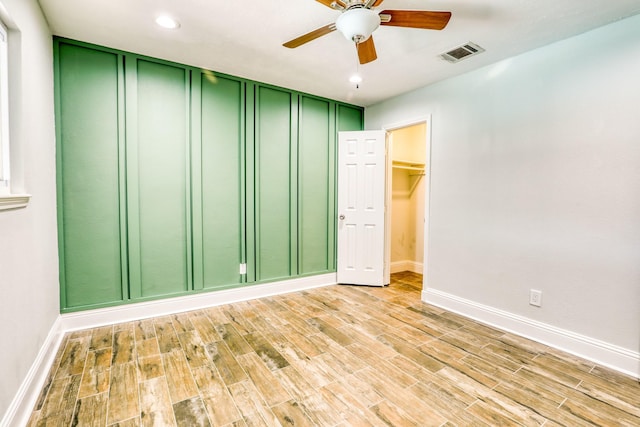 spare room featuring a ceiling fan, baseboards, visible vents, wood tiled floor, and recessed lighting