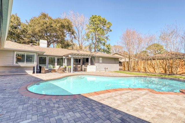 view of swimming pool with outdoor dry bar, a pergola, fence, a fenced in pool, and a patio area