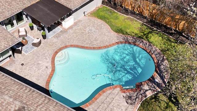 view of swimming pool with a patio and a fenced backyard