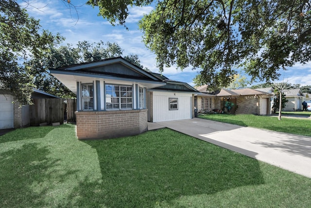 view of front of house with a front lawn, fence, and brick siding