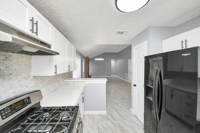 kitchen featuring stainless steel gas range oven, visible vents, under cabinet range hood, white cabinetry, and black refrigerator with ice dispenser