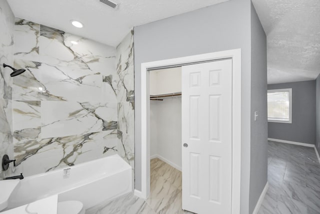 bathroom featuring visible vents, marble finish floor, a textured ceiling, and shower / bathtub combination