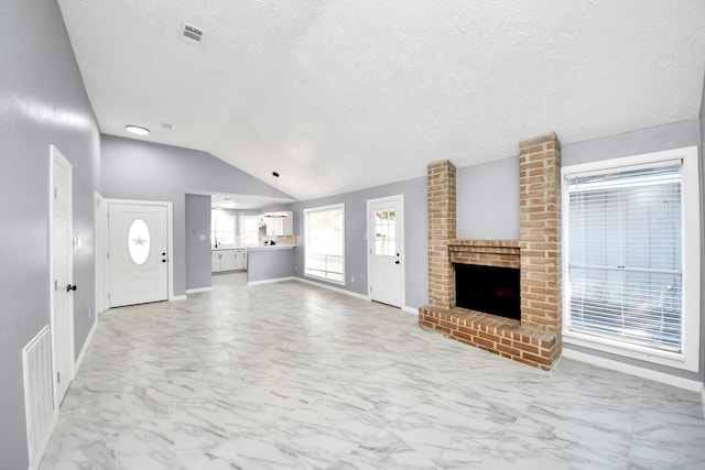 unfurnished living room featuring visible vents, baseboards, vaulted ceiling, a fireplace, and marble finish floor