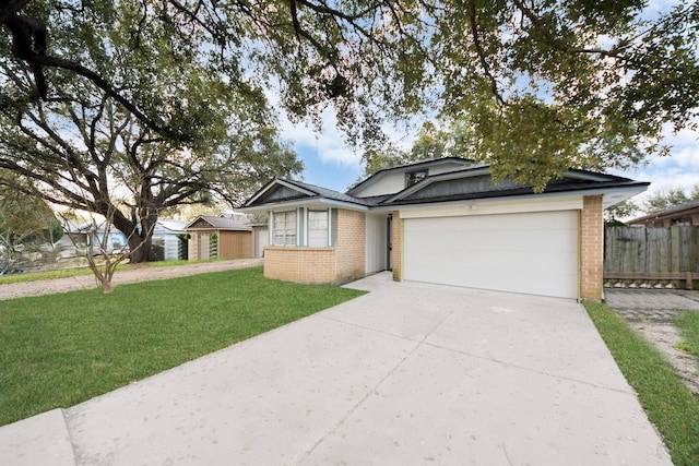 single story home with a front lawn, fence, concrete driveway, a garage, and brick siding