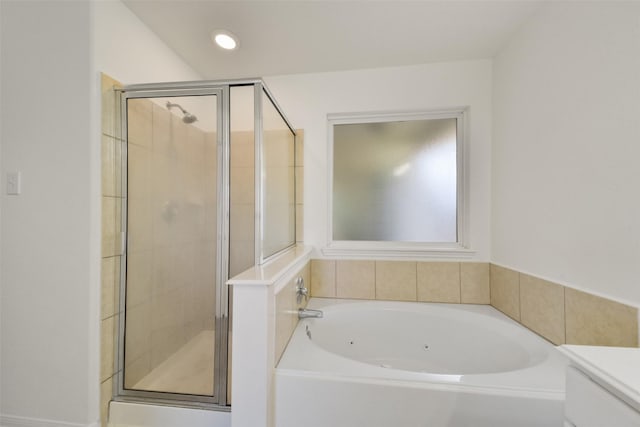 full bath with recessed lighting, a shower stall, and a garden tub