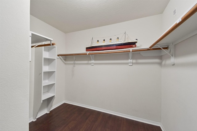 walk in closet featuring dark wood-style floors and visible vents