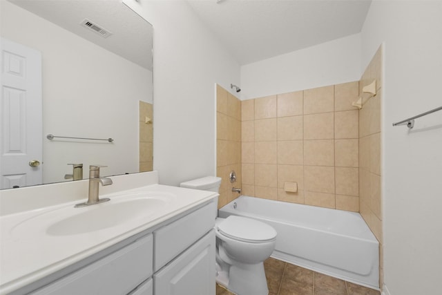 bathroom featuring vanity, visible vents, shower / bath combination, tile patterned floors, and toilet